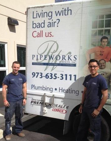 pipe works employees standing by company van