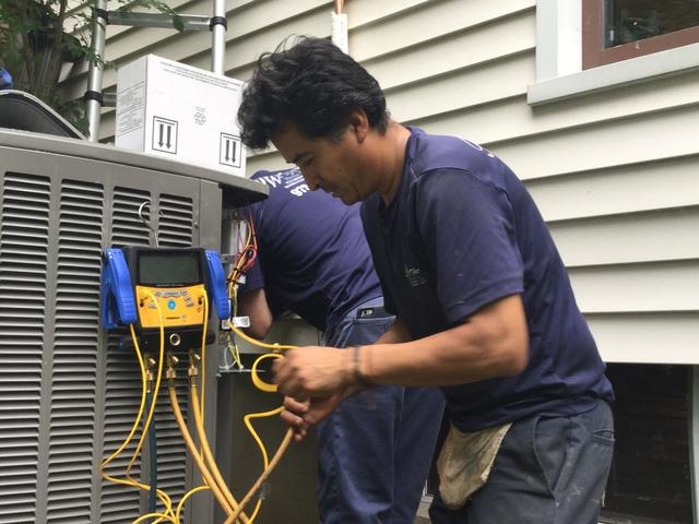 Technician preforming maintenance on HVAC unit