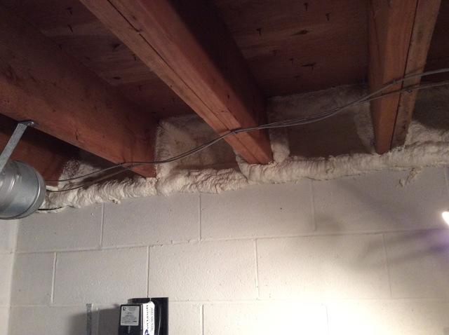 spray foam installed around beams in the ceiling