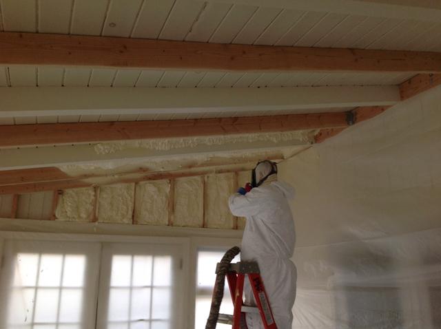 pipe works employee using spray foam