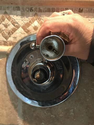 old nozzle for shower being replaced